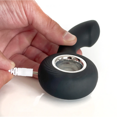 USB charging cable connecting to the base of the black VERS P-Spot rechargeable vibe