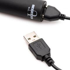 USB magnetic charging cable connected to rechargeable bullet vibrator from the Triple Peg dildo set