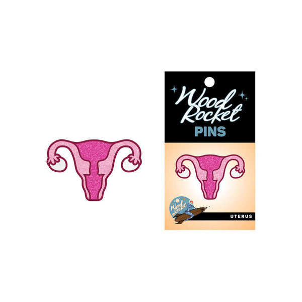 Uterus enamel pin beside its Wood Rocket retail card packaging, showing glitter detail