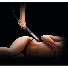 Violet wand probe electrode emitting a purple electrical arc onto a model's lower back during sensory play session