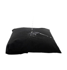 Water beading off Sportsheets Pivot black pillow protector demonstrating waterproof barrier