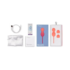 We-Vibe Bloom Kegel Exerciser coral set with USB cable, lube sachet, pouch, and box