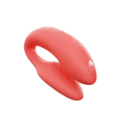 We-Vibe Chorus couples vibrator in coral silicone shown from a curved side angle