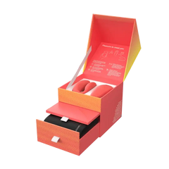 We-Vibe Chorus Crave Coral open gift box with drawer, remote, and coral silicone vibrator