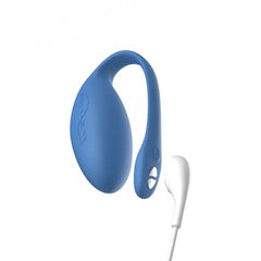 We-Vibe Jive blue egg vibrator connected to white USB magnetic charging cable, side view