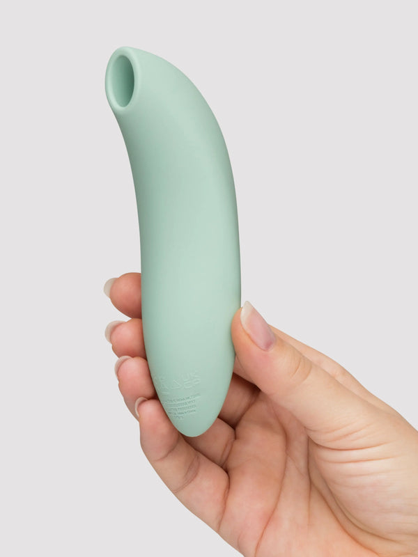 We-Vibe Melt 2 air pulse stimulator in sage green silicone held in a hand, front view
