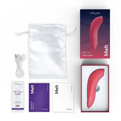 We-Vibe Melt unboxed showing device, satin pouch, USB cable, lube sample, and manuals