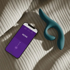 We-Vibe Nova vibrator beside smartphone displaying Nova control screen in the We-Connect app