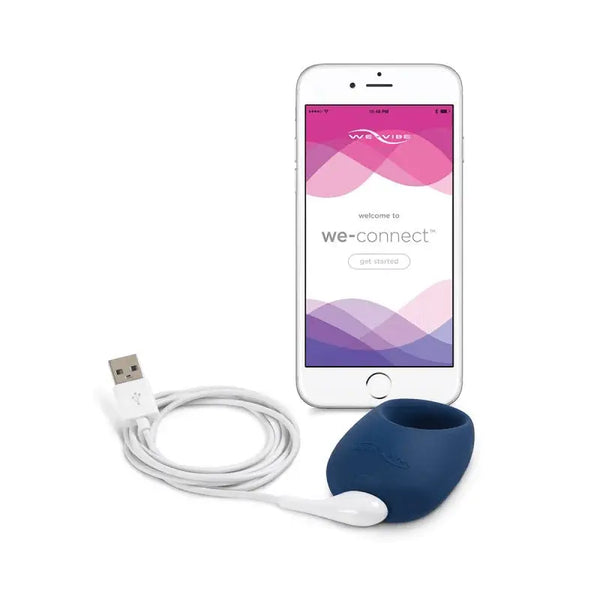 We-Vibe Pivot ring with magnetic USB charging cable and We-Connect app on white smartphone