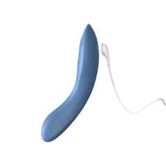 We-Vibe Rave 2 in blue connected to its magnetic USB charging cable