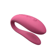 We-Vibe Sync Lite pink silicone couple's vibrator showing U-shape design and textured lower arm