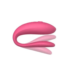 We-Vibe Sync Lite pink vibrator shown from end-on angle highlighting flexible U-shaped silicone form
