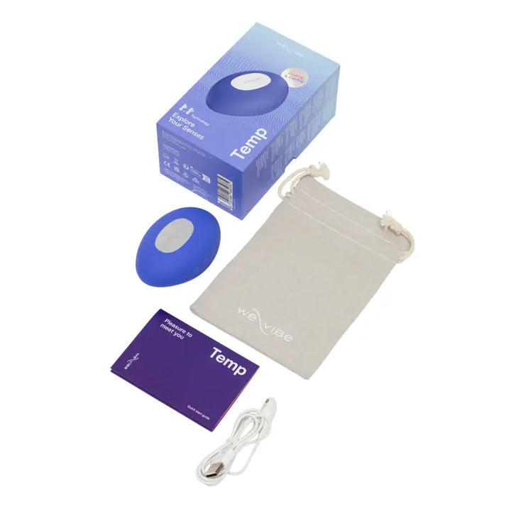 We-Vibe Temp vibrator shown with box, storage pouch, charging cable, and guide