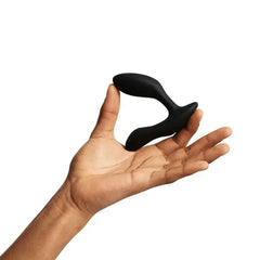 We-Vibe Vector+ prostate massager resting in open palm, showing compact ergonomic size