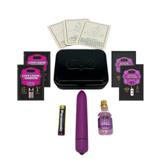 Weekender Kit contents laid out: purple bullet vibrator, lubricant sachets, massage oil, and position cards