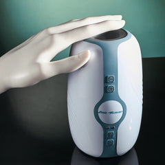 White and teal Touchdown stroker upright on surface with mannequin hand showing scale