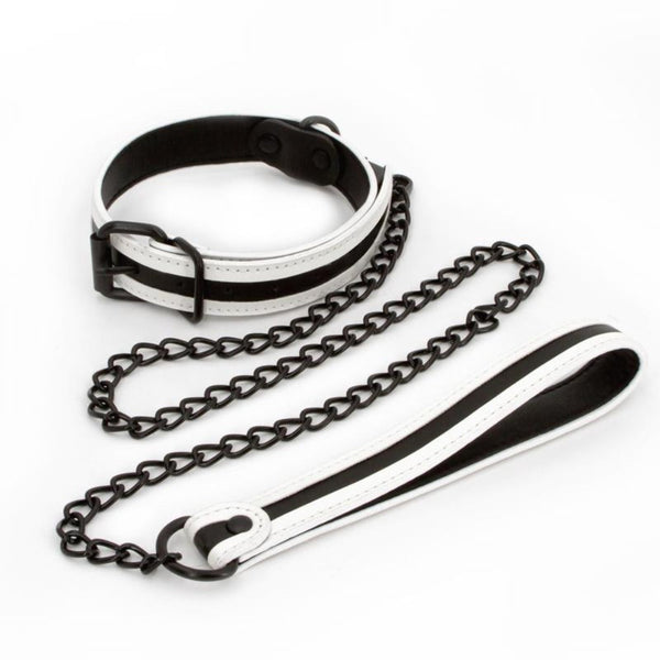 White vegan leather bondage collar and black chain leash set laid flat, showing buckle and handle detail