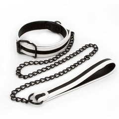 White vegan leather bondage collar and black chain leash set laid flat, showing buckle and handle detail