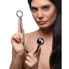 Woman holding The Anal Hook upright, displaying the ring handle and large ball end at chest level
