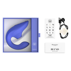 Womanizer Blend unboxed showing device, magnetic USB charging cable, and quick start guide