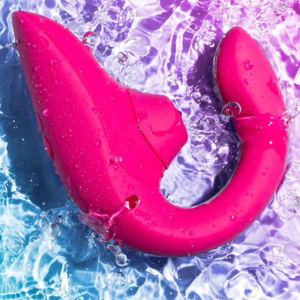 Womanizer Blend vibrant pink silicone vibrator shown wet, highlighting waterproof design