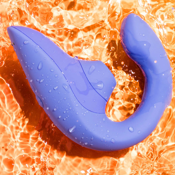 Womanizer Blend waterproof vibrator with water droplets on surface, shown in water