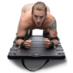 XL Bondage Board used face-down showing padded centre panels and wrist cuffs secured to D-rings
