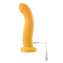 Yellow silicone dildo connected to USB magnetic charging cable, side view