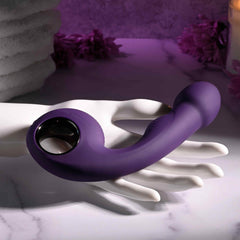 Zero Tolerance Rip Curl purple vibrator resting on white sculptural hand display