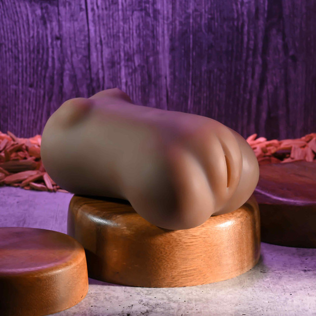 Zero Tolerance Skyler Nicole Wet n' Ready Stroker in deep brown, front view on wooden stand