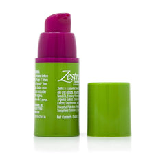 Zestra arousal oil green pump dispenser with pink cap removed showing label and ingredient text