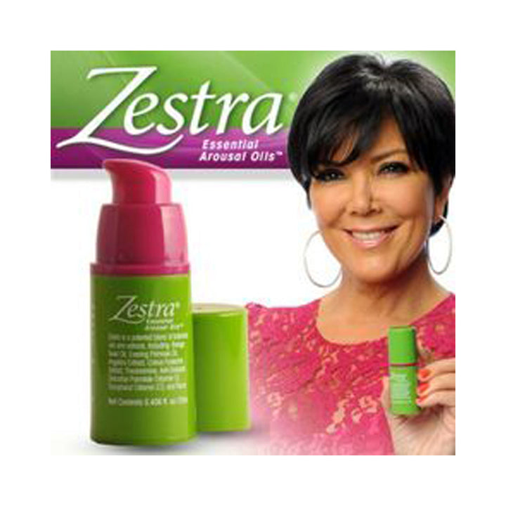 Zestra Essential Arousal Oils pump bottle in green and pink beside a smiling female spokesperson
